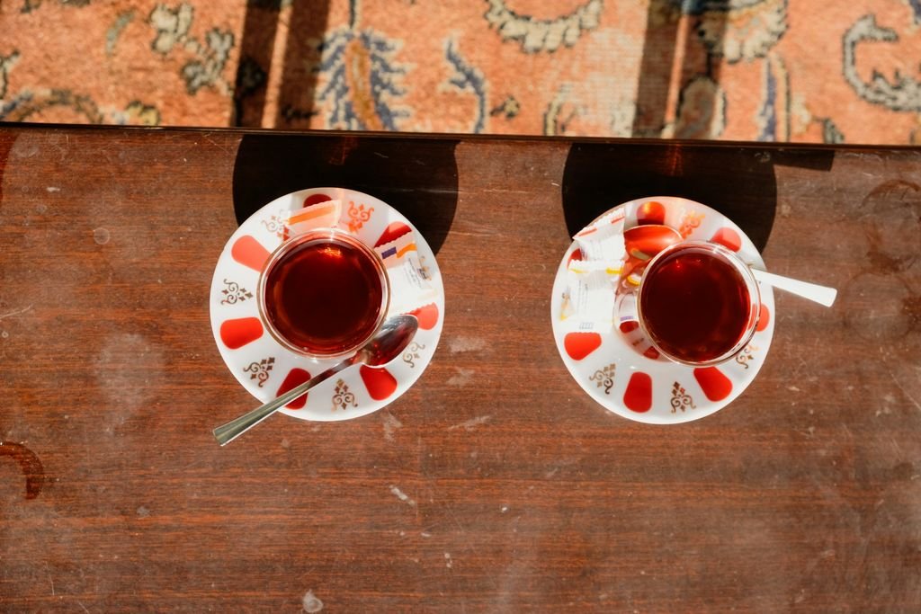 Ahşap masa üzerinde ince belli bardaklarda iki çay